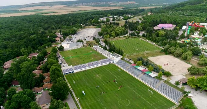Aerial view of many football, soccer fields. Children are playing football. A football tournament