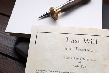 Last Will and Testament, books, stamp seal and pen on wooden table, closeup