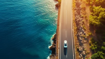 Zelfklevend Fotobehang Aerial view of car driving on asphalt highway road near the ocean. Sun shine. Travel concept. Generative AI © AngrySun