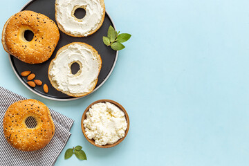 Homemade baked bread bagels with cheese cream. Healthy breakfast background