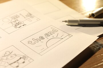 Storyboard with cartoon sketches at workplace, closeup. Pre-production process