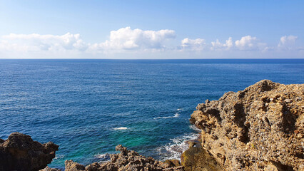 Fototapeta na wymiar Blue sky and rock beach by the sea .