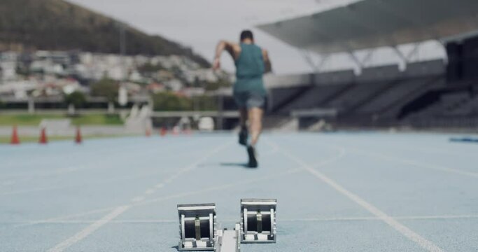 Man, running and starting blocks at race competition ready for challenge, speed or back view. Male person, feet and ground or stadium exercise for marathon performance athlete, achievement or cardio