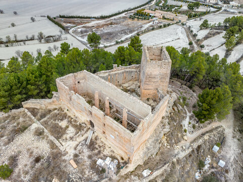 Aerial view of Barxell castle in the municipality of Alcoy, Alicante, Spain. 13th century medieval building standing on a rocky mound in the middle of a pine forest in the valley of Polop. Rectangular