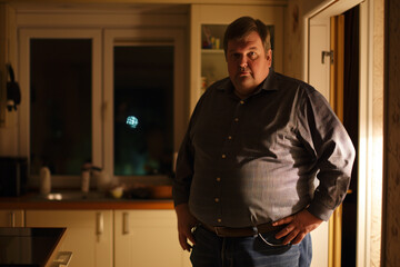 Fototapeta premium Man in Thoughtful Pose in Home Kitchen