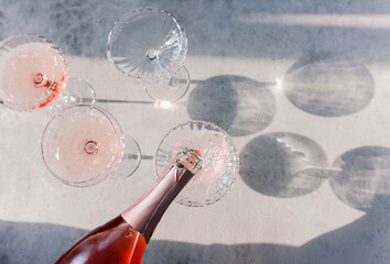 Glasses with cold pink champagne placed on table