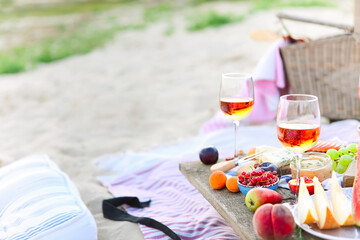 Picnic on the beach at sunset in the style of boho