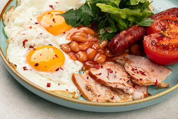 Portion of classic british breakfast with beans and sausages