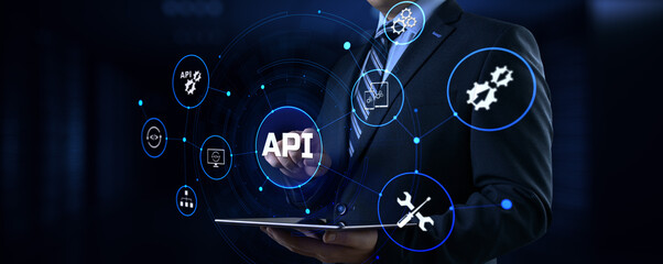 API Application programming interface. Businessman pressing virtual button.
