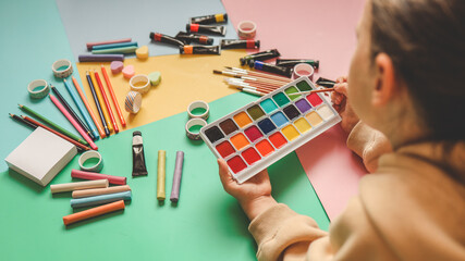 Back to school. Panoramic education banner. Top view, flat lay. Colorful supplies on table, colored paper. Children's creativity concept. Preschool study, development. Accessories for the schoolroom