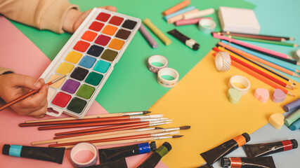 Back to school. Panoramic education banner. Top view, flat lay. Colorful supplies on table, colored paper. Children's creativity concept. Preschool study, development. Accessories for the schoolroom