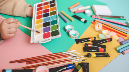 Back to school. Panoramic education banner. Top view, flat lay. Colorful supplies on table, colored paper. Children's creativity concept. Preschool study, development. Accessories for the schoolroom