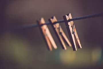 Three clothespins placed artistically on the wire. Minimalist image made in the garden