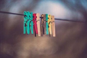 Three clothespins placed artistically on the wire. Minimalist image made in the garden