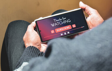 Man watching online streaming video footage on his smartphone. Channel subscriptions notification...