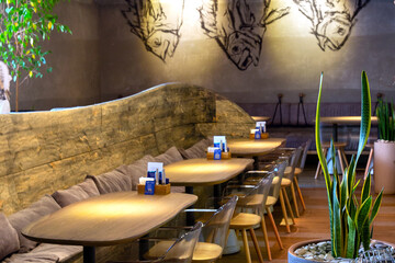 Interior of cozy modern fish restaurant with a bar counter and lamp lighting