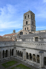 Fototapeta premium Cloister and tower of the Church of St Trophime, Saint Trophime cathedral, Arles, Provence, France.