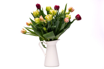 Elegant mixed tulips spring bouquet in a white vase on white background. Spring tulips. Tulips...