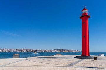 Farol de Cacilhas, Red lighthouse in the port of Almada, located on the southern margin of the...