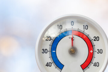 Outdoor thermometer indicates melting point temperature