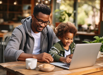 African American father working on laptop while his son distracts him, Little boy being naughty his dad, Multi-tasking, Freelance and fatherhood concept - obrazy, fototapety, plakaty