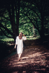 girl in a white dress in the forest