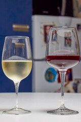 a glass of red wine and a glass of white wine on a table.