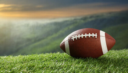 Leather American football ball on green grass. Space for text
