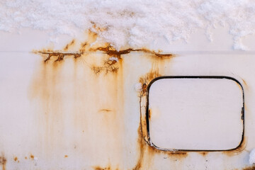 Rust on the fender of a white car