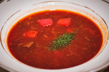 Ukrainian Borscht is a sour soup, made with meat stock, vegetables and seasonings, common in Eastern Europe and Northern Asia, close up