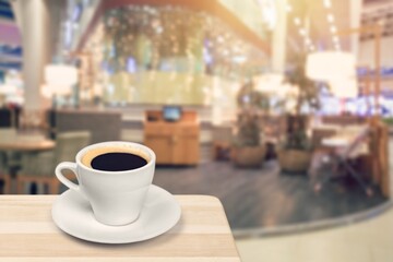 Wooden table at coffee shop  with a cup