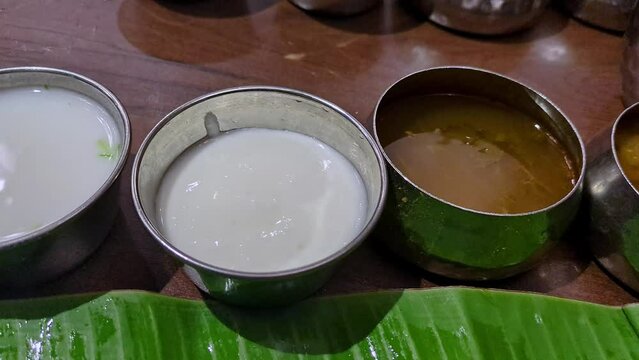 Close-up of variety of Indian Andhra dishes and curries served on a banana leaf in bowls