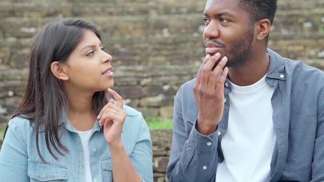 handsome man and beautiful woman hugging each other, walking, talking, having a date in the park	