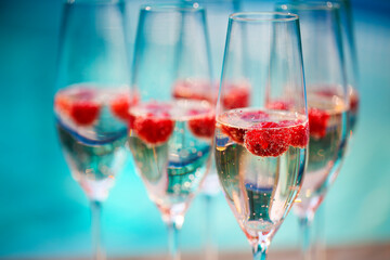 Champagne glasses with raspberry