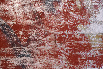 Texture of red colored old wall with layers of worn out paint