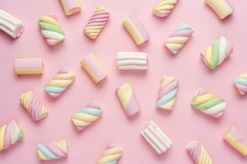 Colorful marshmallows on pink background. Creative minimal sweet holiday backdrop.