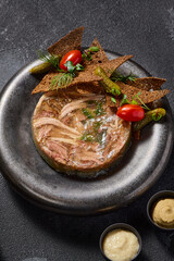 Savory aspic with rye crisps, pickles, mustard, and horseradish, a rich symphony of textures and tastes