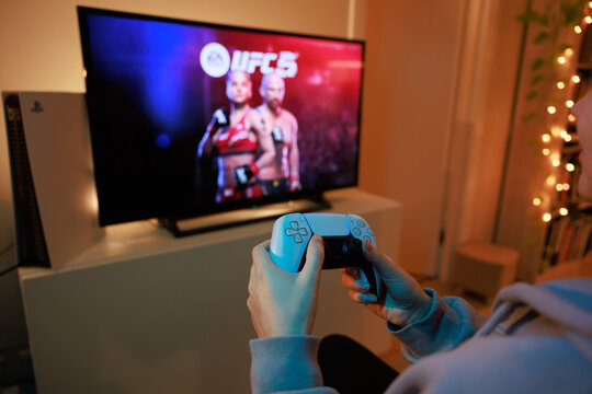 New UFC 5 Sony PS5 console. Dualsense controller. Man holding joystick and ready to play upcoming EA Sports UFC 5