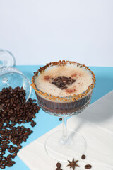 drink. Espresso Martini. coffee drink in a glass on a white-blue background, decorated with coffee beans