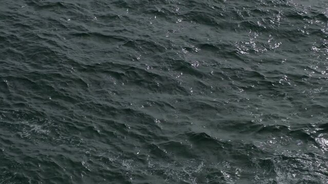 Rippling blue sea or ocean waves. Abstract water surface background. Aerial view