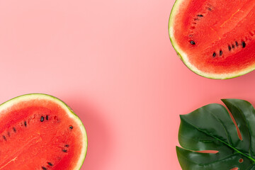 Watermelon with palm tree leaf on pink background. Creative minimal summer concept.