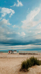 Fluffy storm clouds over empty sandy public beach