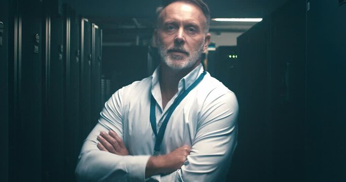 Business man, server room and arms crossed for information technology, cybersecurity or gdpr management. Face of senior technician in data center backup, cloud computing solution or night maintenance