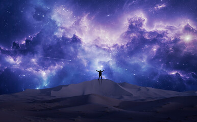 Man with his back watching the universe from a large dune