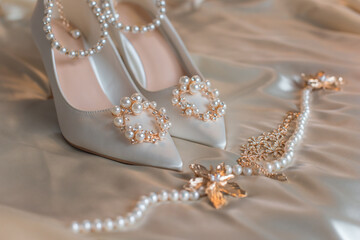 Weddings women white shoes with a heels with a flowers and pearls. Concept of Wedding, accessorize