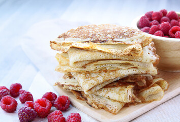 thin French crepe pancakes with fresh berries and honey