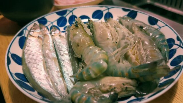 A delightful, healthy seafood meal featuring fish in a bowl with fresh vegetables, served on a white plate