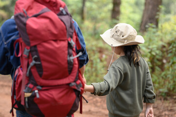 Fototapeta premium Happy traveler brother and girl are on the forest path and on the mountain edge.