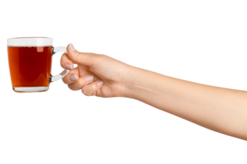 A woman's hand holds a cup of black tea with bergamot in a transparent glass cup. On a blank background