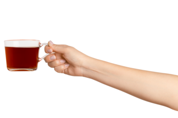 A woman's hand holds a cup of black tea with bergamot in a transparent glass cup. On a blank background
